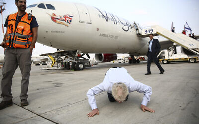 Richard Branson kiss the ground as he arrive to Ben Gurion airport to inaugurate the start of Virgin Atlantic airline in Israel, Wednesday, Oct. 23, 2019 in Tel Aviv, Israel.  (AP Photo/Oded Balilty)