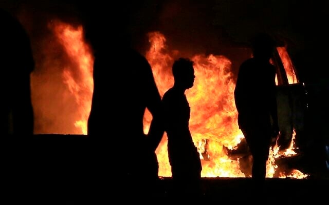 Anti-government protesters burn police vehicles guarding the provincial council during a demonstration in Basra, Iraq, October 25, 2019. (AP Photo/Nabil al-Jurani) Anti-government protesters burn police vehicles guarding the provincial council during a demonstration in Basra, Iraq, October 25, 2019. (AP Photo/Nabil al-Jurani)