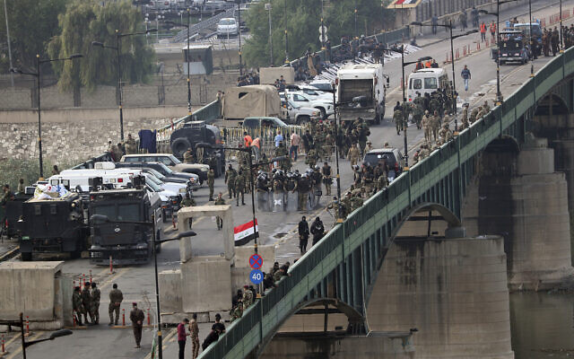 Security forces fire tear gas and close the bridge leading to the Green Zone during a demonstration in Baghdad, Iraq, October 30, 2019. (AP Photo/Hadi Mizban) Security forces fire tear gas and close the bridge leading to the Green Zone during a demonstration in Baghdad, Iraq, October 30, 2019. (AP Photo/Hadi Mizban)