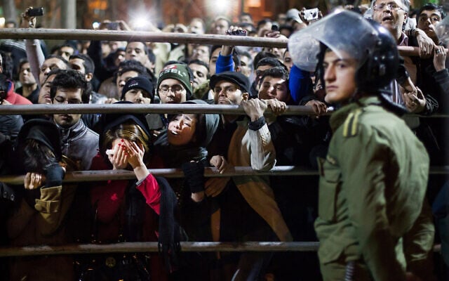 Illustrative -- Iranian women react during the execution of Alireza Mafiha and Mohammad Ali Sarvari, unseen, in Tehran, Iran, January 20, 2013 (AP Photo/Fars, Ebrahim Noroozi) Illustrative -- Iranian women react during the execution of Alireza Mafiha and Mohammad Ali Sarvari, unseen, in Tehran, Iran, January 20, 2013 (AP Photo/Fars, Ebrahim Noroozi)