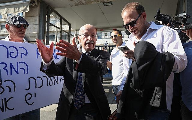 Prime Minister Benjamin Netanyahu's lawyer Ram Caspi (2nd-L) outside the Justice Ministry headquarters on October 2, 2019, ahead of Netanyahu's pre-indictment hearing. (Noam Rivkin Fenton/Flash90)