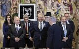 Prime Minister Benjamin Netanyahu approaches rival Benny Gantz as they and other party leaders including Avigdor Liberman and Aryeh Deri prepare to pose for a group picture during the swearing-in of the 22nd Knesset in Jerusalem, on October 3, 2019. (Hadas Parush/Flash90)