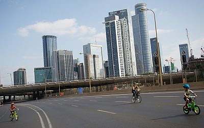 Israelis ride their bicycles along the empty Ayalon highway in Tel Aviv, on Yom Kippur, the Day of Atonement, and the holiest of Jewish holidays, October 9, 2019 (Miriam Alster/Flash 90)