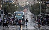 People walk in rainy and windy weather on Jaffa street in Jerusalem, on October 15, 2019. (Yonatan Sindel/Flash90)
