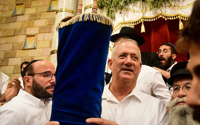 Blue and White party chairmen Benny Gantz carries a Torah scroll as he dance during Simhat Torah celebrations in Kfar Chabad, on October 21, 2019. (Yossi Zeliger/Flash90) Blue and White party chairmen Benny Gantz carries a Torah scroll as he dance during Simhat Torah celebrations in Kfar Chabad, on October 21, 2019. (Yossi Zeliger/Flash90)