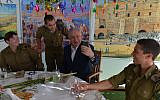 From left to right:  Cpl. Aleksandra Vodenskov, Sgt. Alexander Sachs, Prime Minister Benjamin Netanyahu and Sgt. Eddie Laufer in the prime minister's sukkah in Jerusalem, October 13, 2019 (Koby Gideon/GPO)