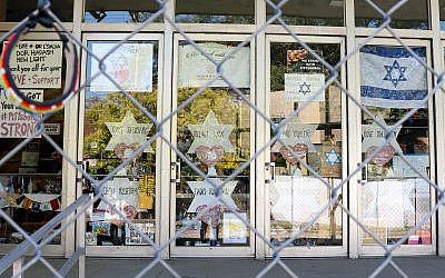 The doors of the Tree of Life synagogue feature memorials surrounding the building nearly a year after the attack there that killed 11 worshipers (Grace Yagel via JTA)