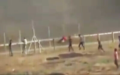 Palestinian teenager Othman Helles climbs the Gaza security fence moments before he is shot by an IDF soldier during a riot along the Strip's border on July 13, 2018. (Screen capture)