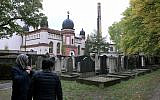 People stand in front of the synagogue in Halle, Germany, October 10, 2019. (AP Photo/Jens Meyer)