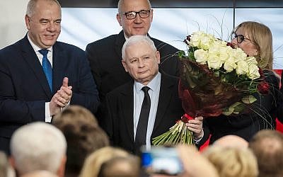 Leader of Poland's ruling party Jaroslaw Kaczynski, center, and party activists react to exit poll results after voting closed in the nation's parliamentary election in Warsaw , Poland, October 13 ,2019. (AP Photo)