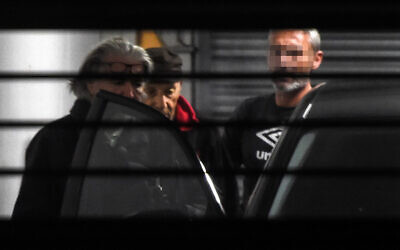 Claude Sinke (R), the octogenarian accused of wounding two men in a shooting at a mosque in southern France and his lawyer Benoit Briffe (L) enter a police car before leaving the Bayonne courthouse on October 30, 2019 where Sinke was charged and ordered held in detention. (Gaizka Iroz/AFP)