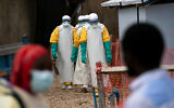 Illustrative: Health workers dressed in protective gear begin their shift at an Ebola treatment center in Beni, Congo DRC, July 16, 2019. (AP Photo/Jerome Delay)