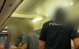 An Israeli man being removed from a flight by Sicily police after he demanded to be seated near his son, in undated footage released on October 21, 2019. (Screenshot: Facebook)