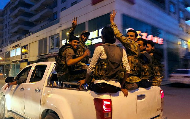 Turkish-backed Syrian opposition fighters from the Syrian National Army drive through the town of Akcakale, Sanliurfa province, southeastern Turkey, on their way to cross the border to Tel Abyad, Syria, October 11, 2019. (AP Photo/Emrah Gurel) Turkish-backed Syrian opposition fighters from the Syrian National Army drive through the town of Akcakale, Sanliurfa province, southeastern Turkey, on their way to cross the border to Tel Abyad, Syria, October 11, 2019. (AP Photo/Emrah Gurel)