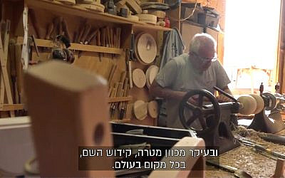 A worker in Kibbutz Lavi's carpentry factory. (Screenshot/Channel 13)