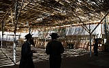 Illustrative: Jews in a sukkah in Jerusalem, September 21, 2015. (Nati Shohat/Flash90)