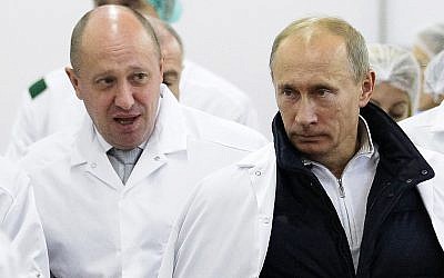Russian businessman Yevgeny Prigozhin, left, shows Russian President Vladimir Putin, right, around his factory outside St. Petersburg, Russia, September 20, 2010. (Alexei Druzhinin/Pool Photo via AP, File)