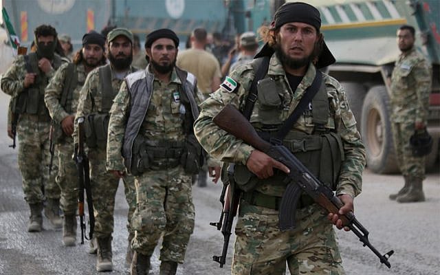 Turkey-backed Syrian fighters walk near the Turkish village of Akcakale along the border with Syria on October 11, 2019, as they prepare to take part in the Turkish-led assault on northeastern Syria. (Bakr Alkasem/AFP) Turkey-backed Syrian fighters walk near the Turkish village of Akcakale along the border with Syria on October 11, 2019, as they prepare to take part in the Turkish-led assault on northeastern Syria. (Bakr Alkasem/AFP)