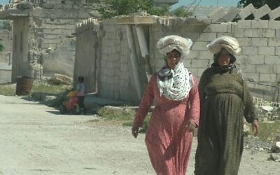 Women walk on the streets of Kobani, Syria. (Ziv Genesove/Times of Israel)