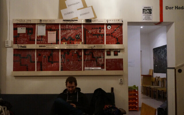 A man looks at his cellphone at the Aurora center in Budapest, Jan. 12, 2017. (Cnaan Liphshiz)