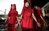 Members of the Extinction Rebellion Red Rebel Brigade take part in a rally calling for action against climate change in Tel Aviv on October 10, 2019. (Tomer Neuberg/Flash90)