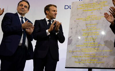 Consistoire President Joel Mergui, left, and French President Emmanuel Macron celebrate the inauguration of a new Jewish community center in Paris, October 29, 2019. (Consistoire)