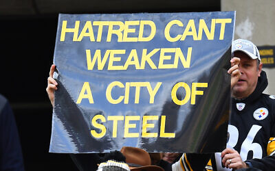 A fan holds up a sign to honor the victims of the shooting at the Tree of Life Synagogue during the game between the Pittsburgh Steelers and the Cleveland Browns at Heinz Field on October 28, 2018 in Pittsburgh, Pennsylvania. (Photo by Joe Sargent/Getty Images via JTA)