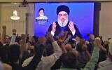 Supporters of Hassan Nasrallah, the head of Lebanon's Hezbollah terror group, watch him speak through a giant screen at a mosque in the Lebanese capital Beirut's southern suburbs on November 1, 2019. (AFP)