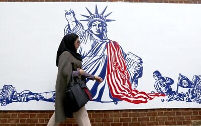 An Iranian woman walks past a new mural painted on the walls of the former US embassy in the capital Tehran, on November 2, 2019. (Atta Kenare/AFP)