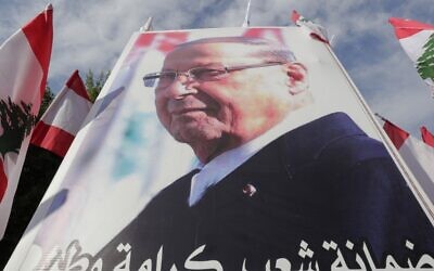 Supporters of Lebanese President Michel Aoun hold a poster of him during a counter-protest near the presidential palace in Baabda on November 3, 2019 (ANWAR AMRO / AFP)