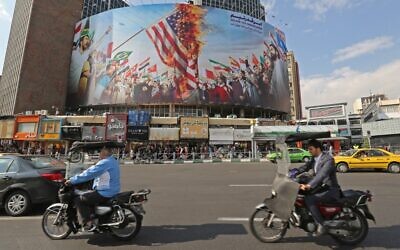 A new giant billboard, designed to to mark the 40th anniversary of the Iran hostage crisis, covers the facade of a building in the Iranian capital Tehran, on November 4, 2019. (ATTA KENARE / AFP)