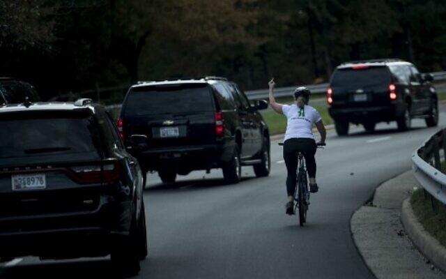 In this file photo taken on October 29, 2017 Juli Briskman gestures with her middle finger as a motorcade with US President Donald Trump departs Trump National Golf Course in Sterling, Virginia. (Photo by Brendan Smialowski / AFP) In this file photo taken on October 29, 2017 Juli Briskman gestures with her middle finger as a motorcade with US President Donald Trump departs Trump National Golf Course in Sterling, Virginia. (Photo by Brendan Smialowski / AFP)