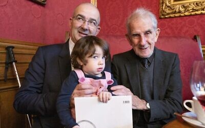 Two-year-old Emmy de Waal is held by her father John de Waall (L) and grandfather Victor de Waal during their reunion in Vienna, Austria on November 4, 2019. Ephrussi family members returned to Vienna in November for their first reunion in more than eight decades to attend the opening of an exhibition about their family story (JOE KLAMAR / AFP)