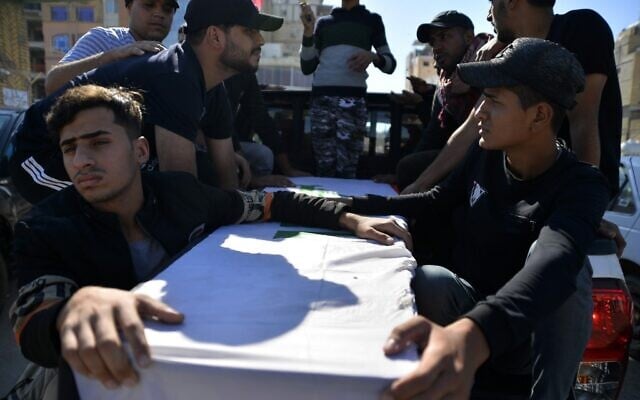 Mourners carry the casket of an Iraqi protester who was killed the day before during protests in the capital, during his funeral in the central Iraqi city of Najaf on November 10, 2019. (Haidar Hamdani/AFP) Mourners carry the casket of an Iraqi protester who was killed the day before during protests in the capital, during his funeral in the central Iraqi city of Najaf on November 10, 2019. (Haidar Hamdani/AFP)