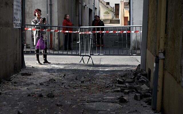 A woman takes a picture of bricks which fell from a wall in Le Teil, southeastern France, on November 11, 2019, after an earthquake with a magnitude of 5.4 hit the area. (Jeff Pachoud/AFP) A woman takes a picture of bricks which fell from a wall in Le Teil, southeastern France, on November 11, 2019, after an earthquake with a magnitude of 5.4 hit the area. (Jeff Pachoud/AFP)