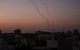 Illustrative: Palestinians fire rockets from Gaza City toward Israel on November 12, 2019. (Photo by MAHMUD HAMS / AFP)