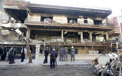 Security forces and municipality workers outside a building targeted by an airstrike in the Syrian capital Damascus' Mazzeh neighborhood overnight on November 12, 2019. (LOUAI BESHARA / AFP)