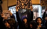 Demonstrators hold banners reading "I accuse: Polanski Rapist" during a protest against French-Polish film director Roman Polanski outside the "Champo" cinema hall in Paris on November 12, 2019. (Christophe ARCHAMBAULT/AFP)
