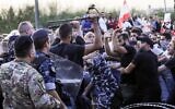 Lebanese demonstrators clash with anti-riot police on the road leading to the Presidential Palace in Baabda, on the eastern outskirts of Beirut on November 13, 2019, nearly a month into an unprecedented anti-graft street movement. (Anwar Amro/AFP)