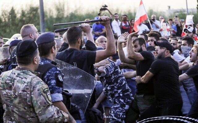 Lebanese demonstrators clash with anti-riot police on the road leading to the Presidential Palace in Baabda, on the eastern outskirts of Beirut on November 13, 2019, nearly a month into an unprecedented anti-graft street movement. (Anwar Amro/AFP) Lebanese demonstrators clash with anti-riot police on the road leading to the Presidential Palace in Baabda, on the eastern outskirts of Beirut on November 13, 2019, nearly a month into an unprecedented anti-graft street movement. (Anwar Amro/AFP)
