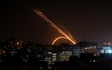 Illustrative: Rockets are fired from the Gaza Strip toward Israel, on November 13, 2019. (Anas Baba/AFP)