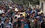 Palestinians attend the funeral procession of members of the same family who were killed overnight in an Israeli airstrike, on November 14, 2019 in Deir al-Balah.  (Mahmud Hams/AFP)