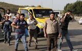 A picture taken from the Israeli side of Tarkumiya checkpoint near the southern city of Kiryat Gat shows Palestinian workers crossing into Israel to reach their jobs on November 14, 2019 (HAZEM BADER / AFP)