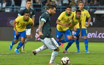 Argentina's forward Lionel Messi runs up to take a penalty during the friendly football match between Brazil and Argentina at the King Saud University stadium in the Saudi capital Riyadh on November 15, 2019. (Photo by Fayez Nureldine / AFP)