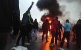 Iranian protesters gather around a fire during a demonstration against an increase in gasoline prices in the capital Tehran, on November 16, 2019. (AFP/ File)