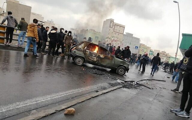 Iranian protesters gather around a burning car during a demonstration against an increase in gasoline prices in the capital Tehran, on November 16, 2019. (AFP) Iranian protesters gather around a burning car during a demonstration against an increase in gasoline prices in the capital Tehran, on November 16, 2019. (AFP)