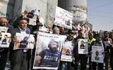 Palestinian journalists wear eye patches as they gather for a demonstration by Israel's security barrier in Bethlehem in the occupied West Bank on November 17, 2019, while holding posters of and signs in solidarity with Palestinian cameraman Mu'ath Amarneh, who, days before, was injured in his eye by a rubber bullet while covering clashes between Palestinian protesters and Israeli security forces, in a West Bank demonstration. (HAZEM BADER / AFP)