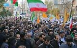Iranians wave national flags during a protest in support of the Islamic Republic's government and supreme leader, Ayatollah Ali Khamenei, in the northwestern city of Ardabil on November 20, 2019, as President Hassan Rouhani says the country's people had defeated an "enemy conspiracy" behind a wave of violent street protests. (STR/AFP)