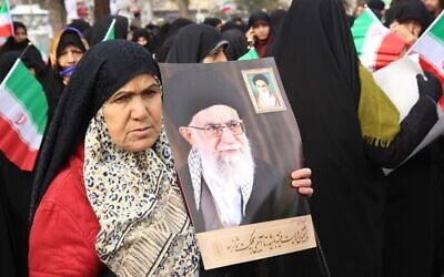 Iranian government supporters rally on November 20, 2019 in support of the Islamic republic's authorities and supreme leader, Ayatollah Ali Khamenei (portraits), in the cenral city of Arak, southwest of the capital Tehran (STR / AFP)