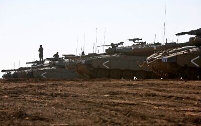 An Israeli soldier stands on a Merkava tank deployed on the Golan Heights on November 20, 2019. (JALAA MAREY / AFP)